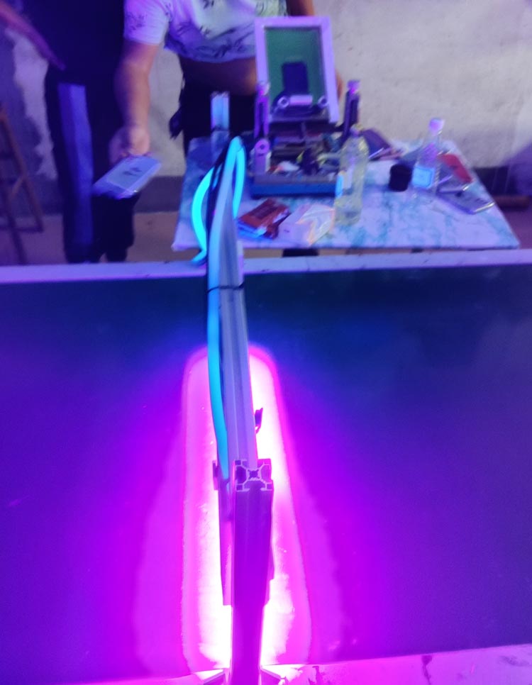 Factory production line using LED‑UV curing equipment to harden screen‑printed ink on workpieces
